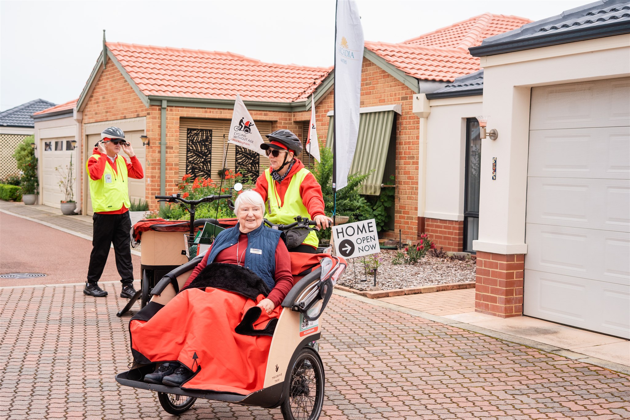 Trishaws in front of a home open